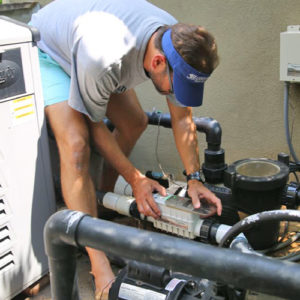 pool inspector in dunwoody looks at pool pump
